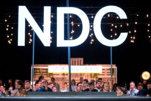 NDC logo on the main stage with audience in the background